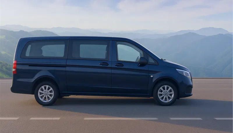 Imagen de cabecera del post alquiler de furgoneta 9 plazas o dos coches cual es la mejor opcion para tu alquiler de coches en asturias que muestra una furgoneta color azul con el fondo montañas de asturias